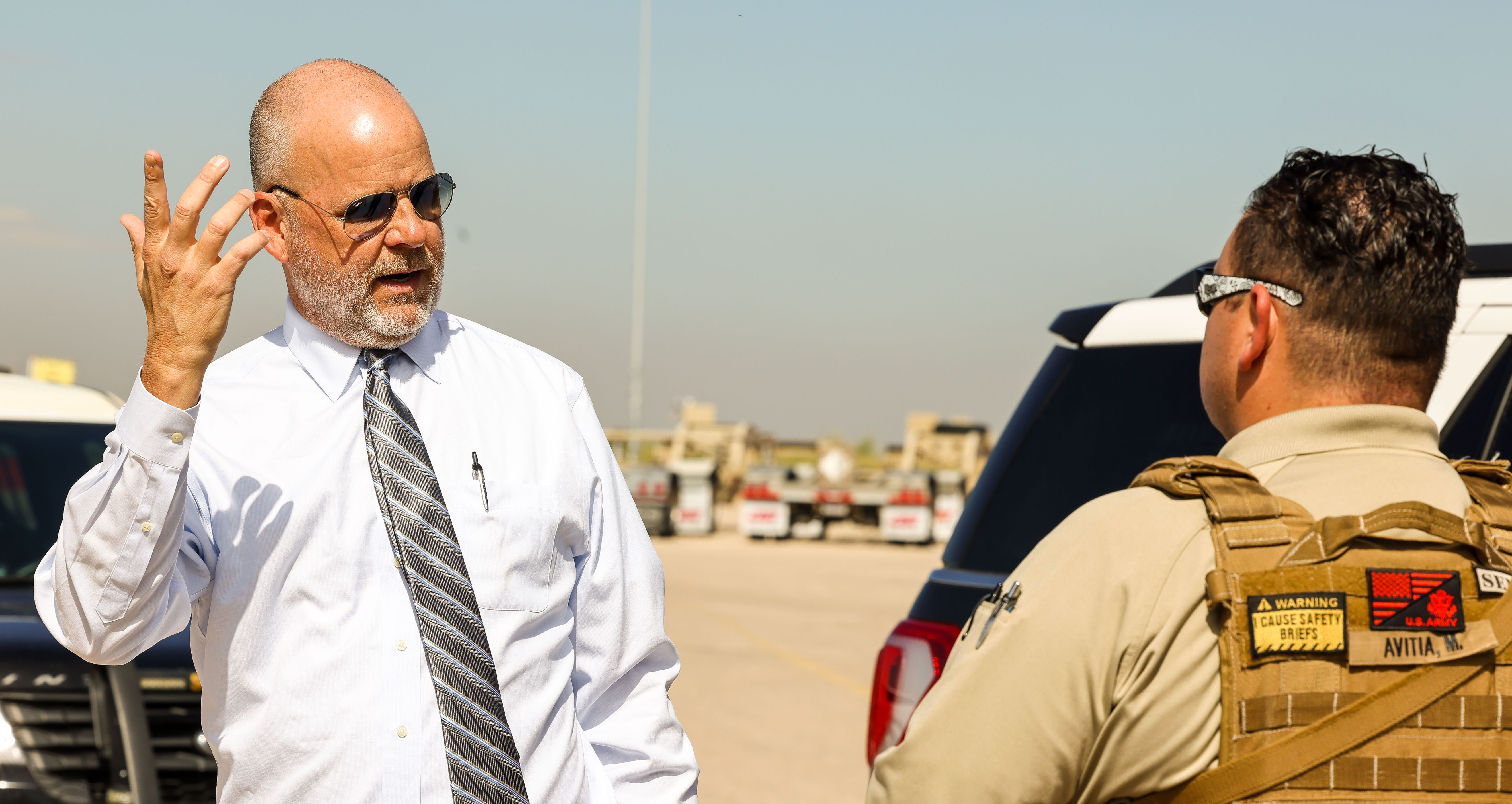 A security personnel is pestered by a media member during the exercise